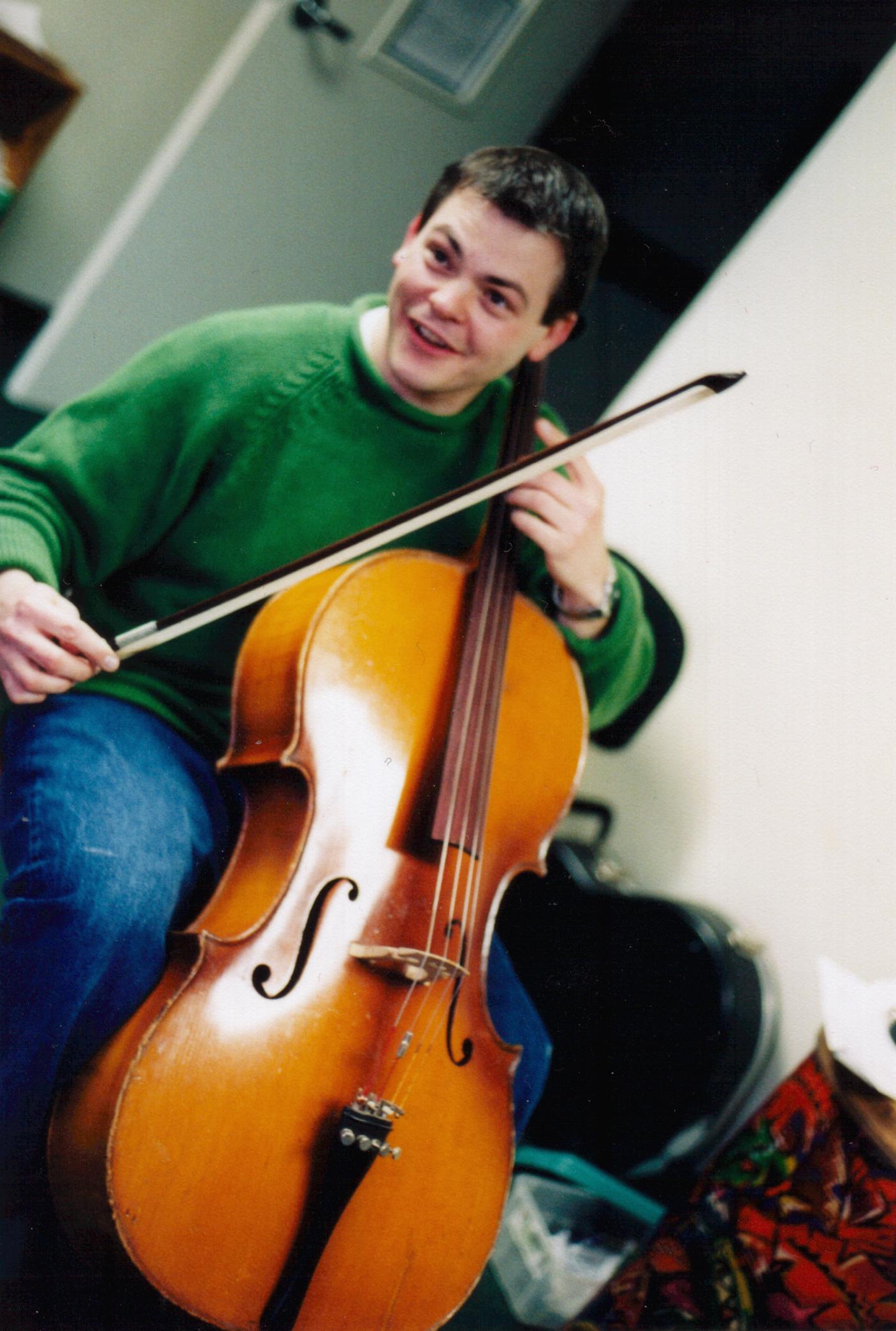 Cliff trying out the cello for the first time