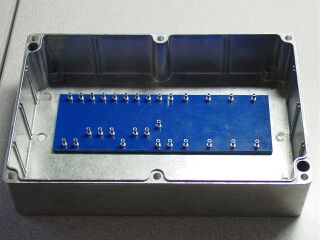 Turret board with ground buss in die-cast box