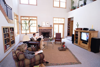 A couple enjoying their home entertainment center - Get a quality home entertainment system from Carr TV.
