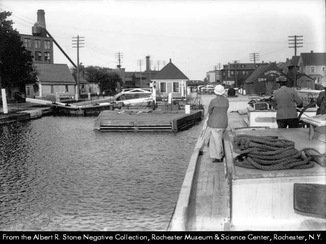 Image of woman on canal boat approaching lock 66 circa 1918.