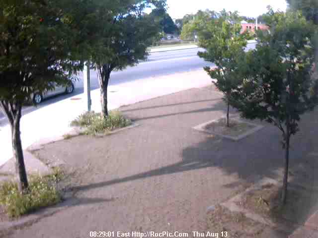 Rochester New York Photo, Monroe Ave, Live Cam. Starbucks Coffee Shop, Plumhouse Plumgarden Japanese Restaurant, North Bound Traffic Foreground. A Road And Parking Lot Runs Between The Businesses, And The Large Multi Family Home In Center Background. Blessed Sacrament Church In Right Background. View Looking North Over Monroe County To Lake Ontario And Canada. Very Good Night Viewing. Click Image To Enlarge To 640 X 480