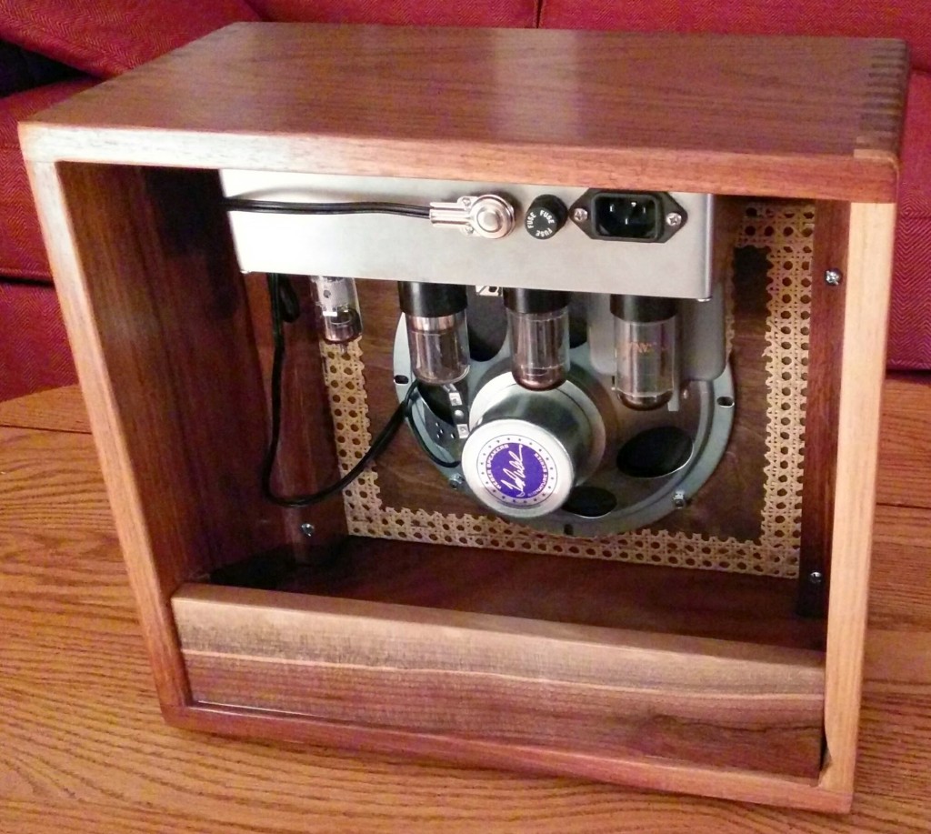Oblique rear view of amplifier
              cabinet in walnut, wicker, and copper