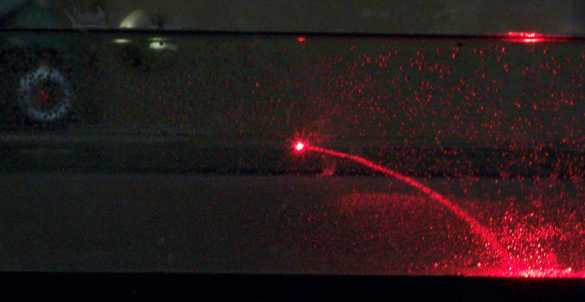 Refracted laser light bent by layered sugar solutions
